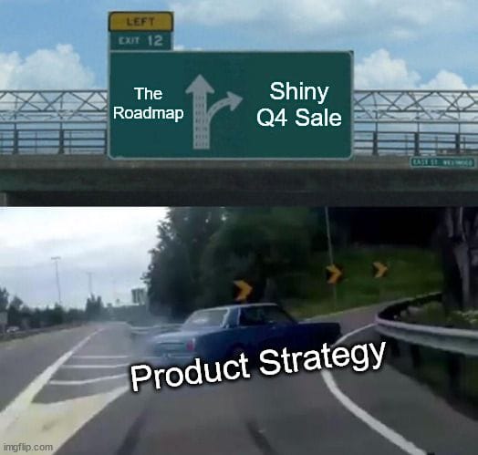 A boxy old blue car spewing black smoke swerves off the highway onto the exit ramp.\n\nThe highway sigh points straight to "The Roadmap". The offramp is labelled "Shiny Q4 Sale". The car is labelled "Product Strategy".